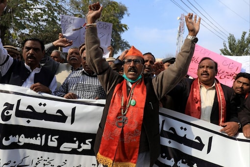 Pakistan’s Hindus carry banners as they chant slogans to condemn forced conversions and attacks on places of worship in Peshawar, Pakistan. (Image: Reuters)