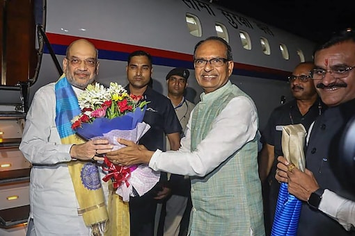 Union Home Minister Amit Shah being welcomed by Madhya Pradesh Chief Minister Shivraj Singh Chouhan upon his arrival, in Bhopal. (PTI)
